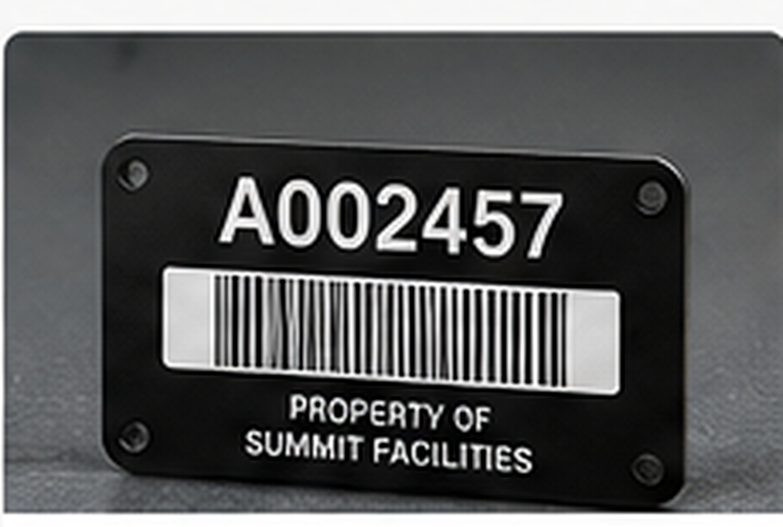 Black asset identification tag with barcode and serial number