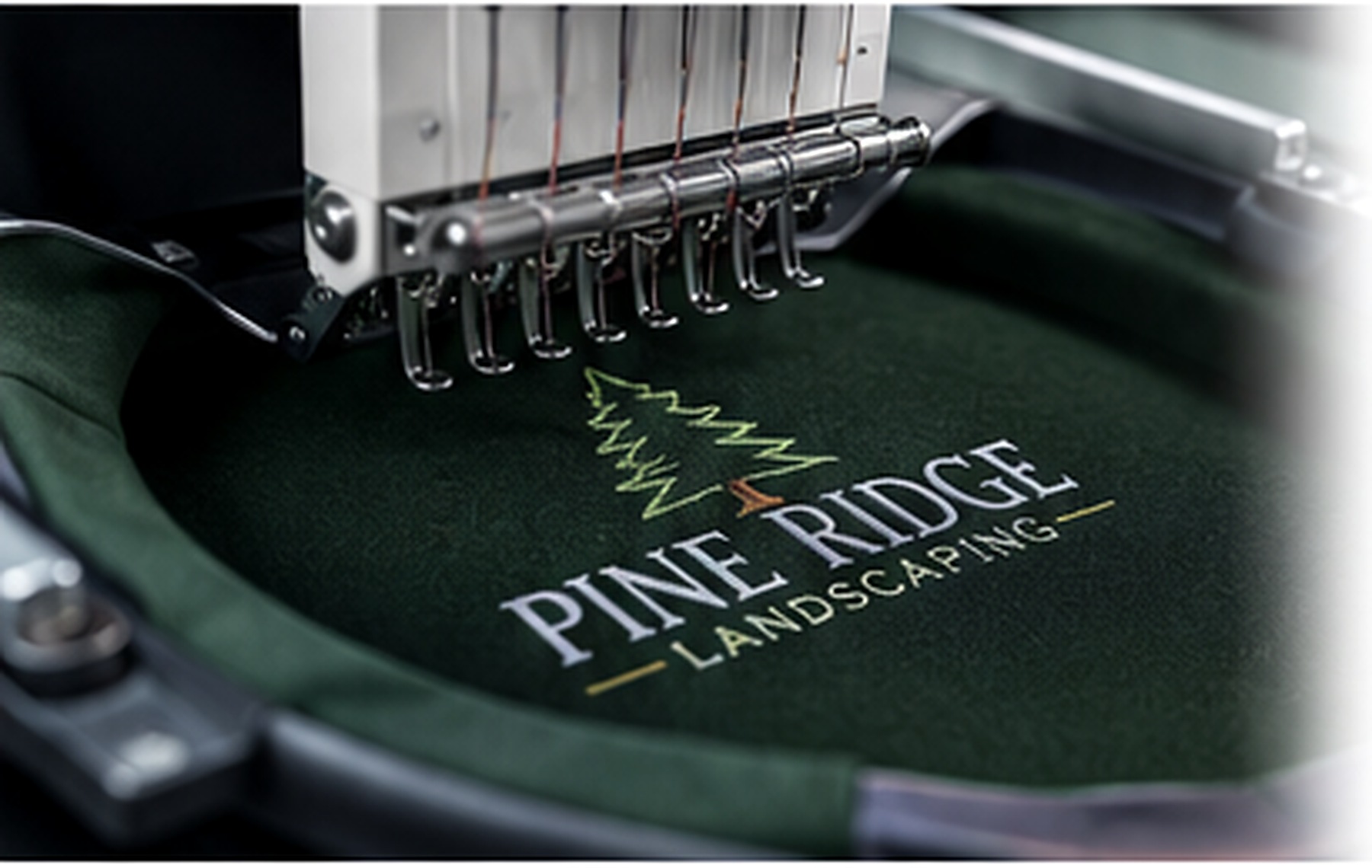 Commercial embroidery machine decorating a branded garment
