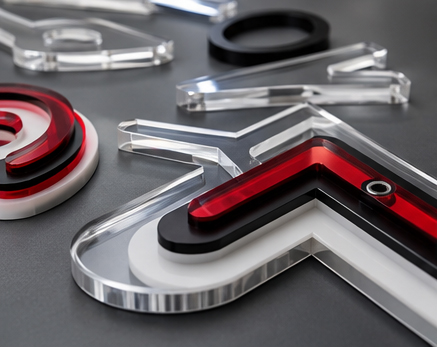 Close-up of precision laser cut dimensional acrylic lettering components