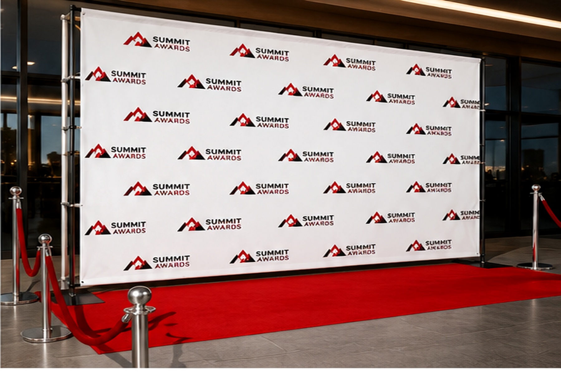 Custom step and repeat backdrop installed along a red carpet at a professional event