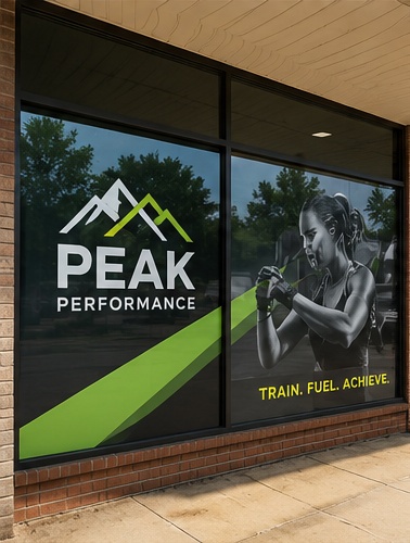 Retail storefront with professionally installed window graphics and door lettering